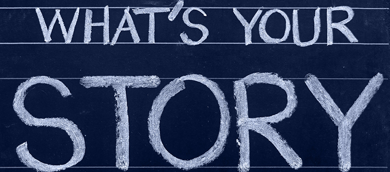 A chalkboard with the text "What's your Story"